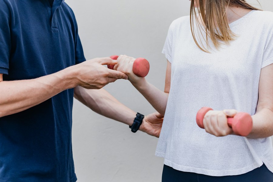A physiotherapist guiding a patient through an exercise with light weights